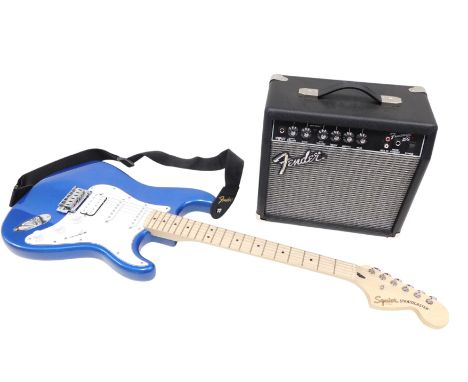 A Squier by Fender Stratocaster guitar, in blue, and a Fender frontman 15G amplifier.