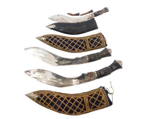 A pair of Indian Kukris, each with a horn handle, and fabric covered scabbard, and another similar. (3)