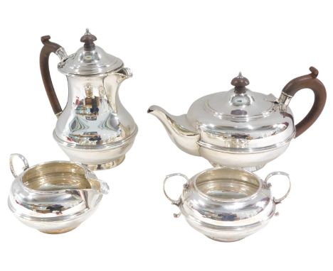 An Elizabeth II silver four piece tea service, the teapot and hot water jug with composition knop and handle, Birmingham 1952
