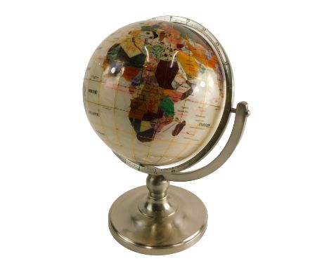 A modern globe, inlaid in semi-precious stones, on a silvered metal stand, 35cm high. 