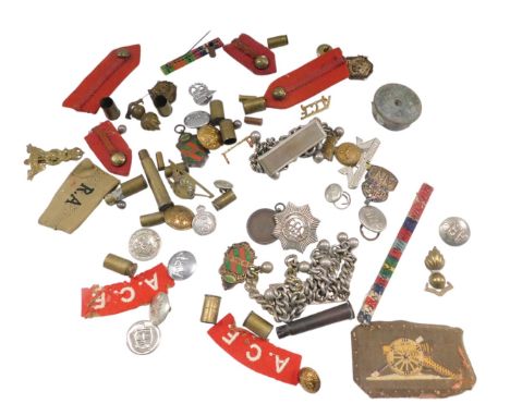 A quantity of militaria, to include buttons, badges, spent brass shells, etc. 