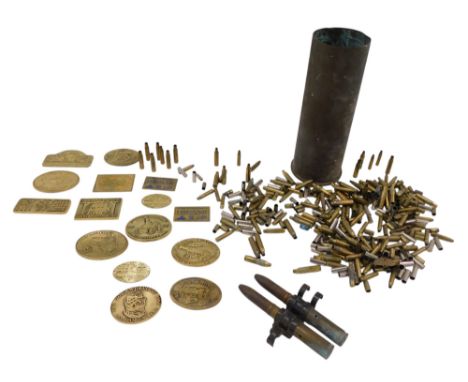 A large quantity of metal ware, to include brass vintage steam event plaques, spent rifle shells, and large artillery shell.