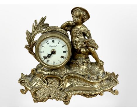 A gilt metal figural mantel clock, the dial signed Imperial, striking on a bell, with key, height 30cm. 