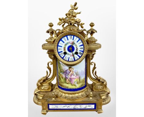 A 19th century French gilt metal and enamelled porcelain mantel clock, striking on a bell, with pendulum and key, height 42cm