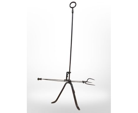 A 19th-century steel toasting fork on tripod stand, height 87cm.