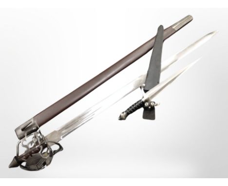 A reproduction basket-hilted sword in scabbard, and a further medieval-style dagger.