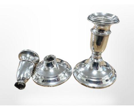 A pair of loaded silver dwarf candlesticks, height 10cm (as found)