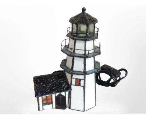 A Tiffany-style table lamp in the form of a lighthouse, height 24cm.