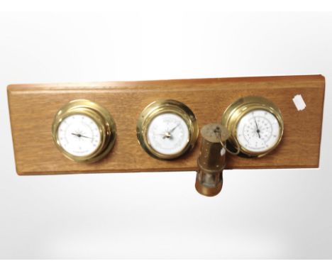 A combination thermometer/barometer/hygrometer mounted on oak board, width 52 cm and a miniature brass miner's lamp 