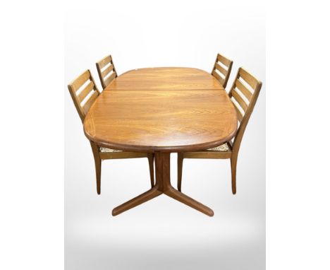 A 20th century teak extending dining table, together with four ladder back dining chairs