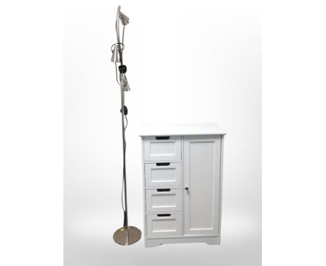 A contemporary white cupboard, width 56 cm and a standard lamp 