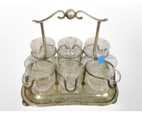 A silver-plated stand containing a set of six glass cups.