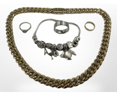 A heavy gold-plated Cuban-style necklace, a 9ct gold band ring, another band ring etched with The Lord's Prayer, a charm brac