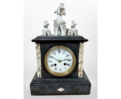 A 19th century marble and slate eight day mantel clock, with three later ceramic dogs above, striking on a bell, with pendulu