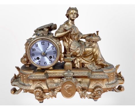 A 19th century French gilt metal figural mantel clock, striking on a bell, with pendulum and key, height 28cm. 