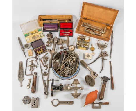 A collection of tools, lathe and small parts for a watchmaker. 