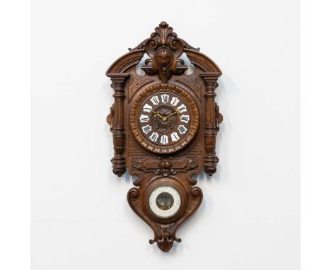 A sculptured cartel clock in walnut, with a barometer in the base. France, the second half of the 19th century. 17 x 47 x 93