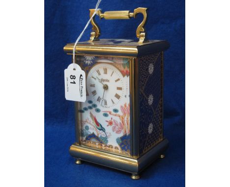 Brass carriage clock with swing handle and Spode porcelain panels.  Quartz movement. CONDITION REPORT: Minor wear but no obvi