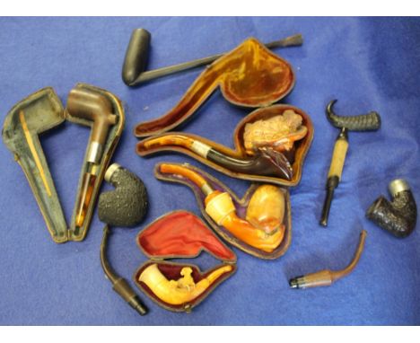 Smoking paraphenalia to include assorted pipes, some cased, silver collared, one in the form of a lady with feather hat, horn