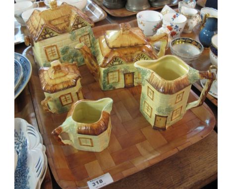 Tray of Staffordshire pottery cottage ware items to include: biscuit barrel; teapot; milk jug; sucrier etc. (5)