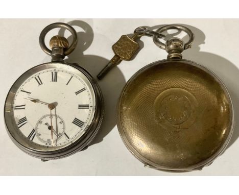 A continental silver hunter pocket watch, engine turned case, vacant shield shaped cartouche, white enamel dial, Roman numera