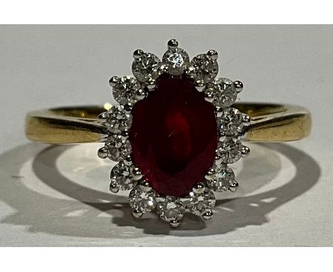 18ct Gold Synthetic Ruby and Diamond ring set with an oval brilliant cut Synthetic Ruby that measures approx. 1.10ct, surroun