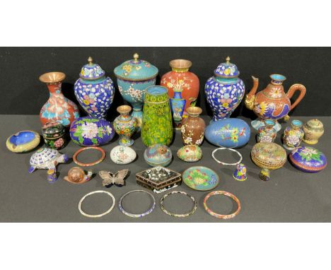 A pair of Chinese cloisonné enamel ginger jars and covers, blossoming prunus patterns on blue grounds within Ruyi borders, sp