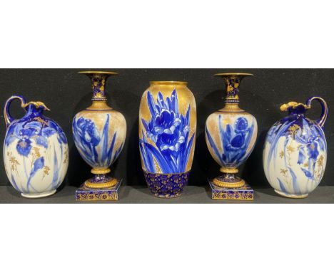 A matched pair of Doulton Blue Iris pattern ovoid pedestal vases, decorated with flow blue irises on a sponged gilt ground, s