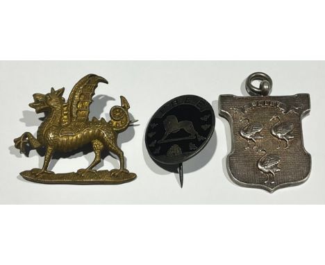 A Victorian silver armorial fob, the Arms of Selby, Yorkshire; an enamel badge, Fellow of the British Empire Exhibition (Wemb