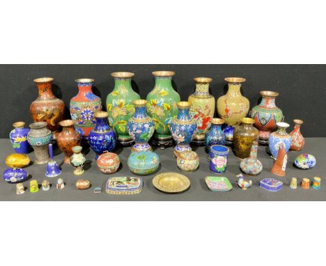 A Chinese cloisonné enamel vase on stand, honeysuckle pattern on a green ground, 22.5cm high, mid-century; others similar of 