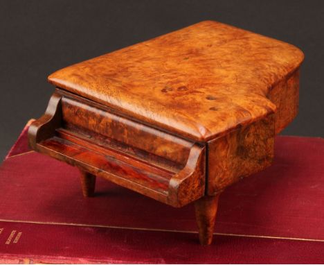 An early 20th century burr walnut novelty musical table vesta, as a grand piano, hinged cover enclosing a match striker, comp