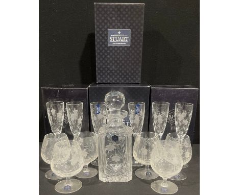 A set of six Stuart Crystal Cascade pattern cut glass Champagne flutes, 21cm, boxed; a Stuart Crystal Cascade pattern decante