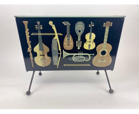WORCESTER WARE MAGAZINE RACK, 1950's English tin plate decorated with various musical instruments, 33cm H x 43cm x 24cm. 