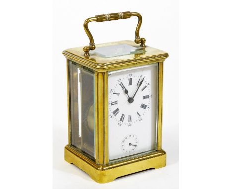 An early 20thC brass carriage clock, of rectangular form, with a five sectional glass case and swing handle, with 5cm wide Ro