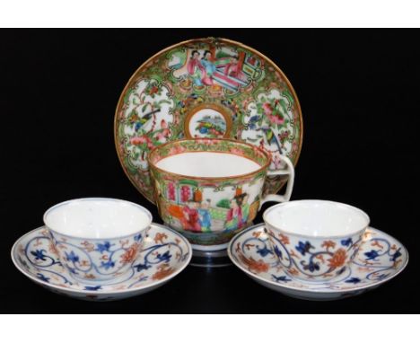 A pair of Chinese Imari 18thC porcelain tea bowls and saucers, in blue and red scrolling peony design, and a 19thC Cantonese 