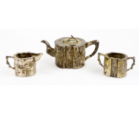 An early 20thC Chinese silver three piece service, comprising teapot, two handled sugar bowl and milk jug, the teapot with sh