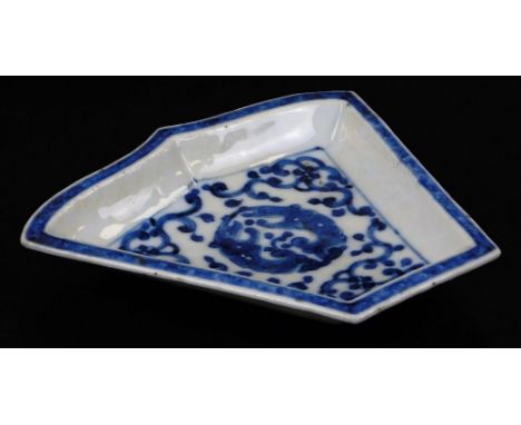 A Chinese porcelain hors d'ouvres segment dish, centred with a disc, outer scroll border and blue and white banding, unmarked
