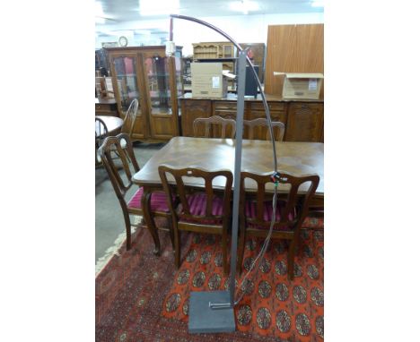 A chrome standard lamp on slate stand