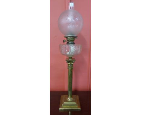 An Art Nouveau brass oil lamp, with cut glass reservoir