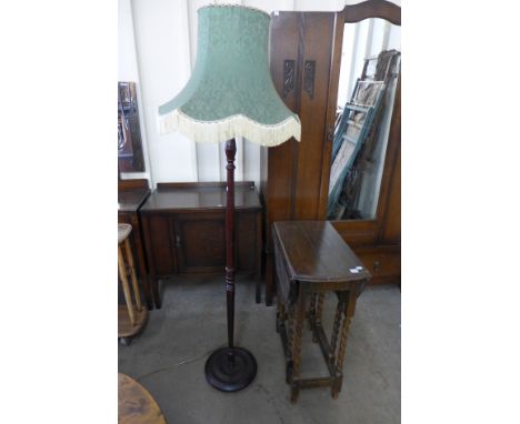 An oak barleytwist gateleg table and a standard lamp