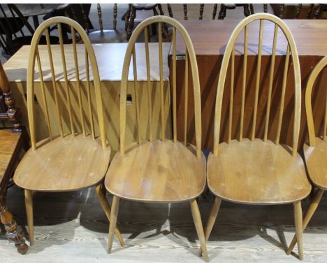 An Ercol blonde elm and beech drop leaf table and three chairs.  