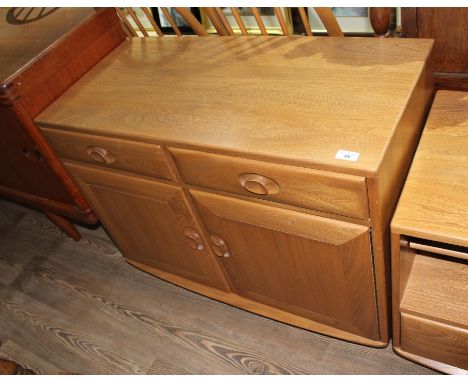 An Ercol light elm cabinet.  