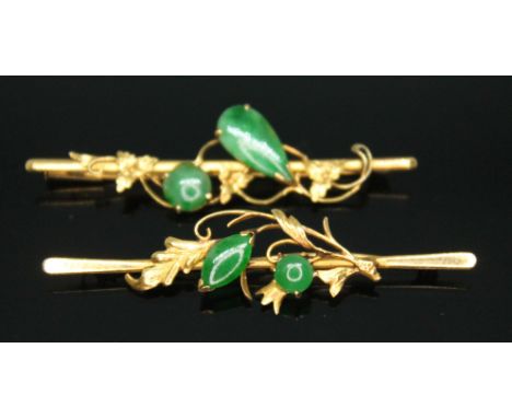 A pair of jadeite jade brooches, one marked with Chinese character marks, length 5cmm each, gross wt. 3.9g.  Condition - one 