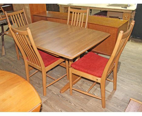 An Ercol light ash extending dining table and four chairs.  