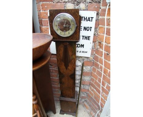 A 1930s walnut small longcase clock, striking on gongs, 13cm high. 