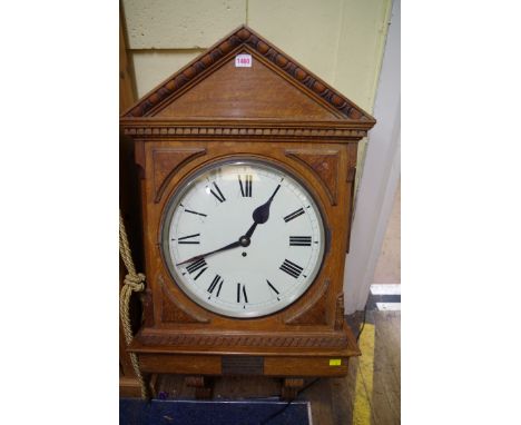 An early 20th century oak wall clock, of architectural form, with fusee movement and 14 inch circular dial, with presentation