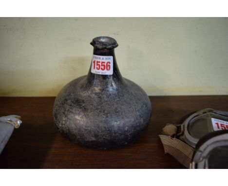 An early 18th century onion form wine bottle, 13cm high.     Condition Report:  Chipping seen around top rim. Calcification t