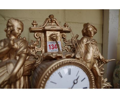 A gilt painted mantel clock.