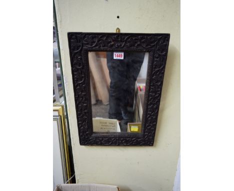 An Eastern carved oak wall mirror, 44 x 31cm. 