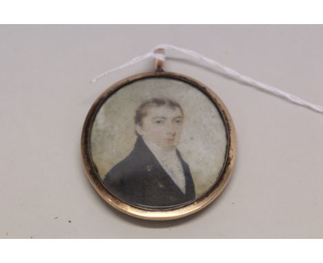 English School, circa 1800, bust length portrait miniature of a gentleman wearing a navy jacket, on ivory with plaited hair t